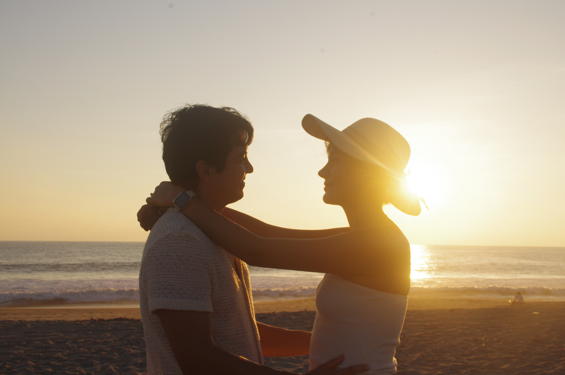 Couple at sunset beach proposal